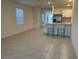 Bright living space featuring tiled floors and a view of the kitchen area with barstool seating at 6783 Grace Hammock Rd, Harmony, FL 34773