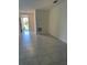 Inviting living room with light grey tiled flooring and a bright, airy atmosphere at 6783 Grace Hammock Rd, Harmony, FL 34773