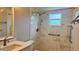 Beautiful bathroom features marble tile, modern fixtures, and updated shower with accessibility features at 804 Wildwood Cir, Port Orange, FL 32127