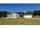 Well-maintained single story home with ample yard space, screened patio, and a two-car garage at 804 Wildwood Cir, Port Orange, FL 32127