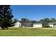 Charming single-story home with a well-manicured lawn and attached two-car garage at 804 Wildwood Cir, Port Orange, FL 32127