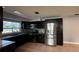 Kitchen featuring stainless steel appliances, dark wood cabinetry, tile backsplash, and tile flooring at 804 Wildwood Cir, Port Orange, FL 32127