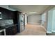 Kitchen with stainless steel appliances, dark wood cabinetry, tile flooring, and tiled backsplash at 804 Wildwood Cir, Port Orange, FL 32127