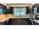 Updated kitchen with granite countertops, stainless steel appliances, and tiled backsplash at 804 Wildwood Cir, Port Orange, FL 32127