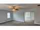 Cozy living room featuring plush carpeting, neutral paint, and ample natural light from the window at 804 Wildwood Cir, Port Orange, FL 32127