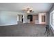 Spacious living room featuring a ceiling fan, neutral walls and carpet, and lots of natural light at 804 Wildwood Cir, Port Orange, FL 32127
