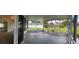 A view of the enclosed lanai/porch overlooking the expansive, green backyard of the property at 804 Wildwood Cir, Port Orange, FL 32127
