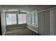 Sun room features neutral paint scheme, plush carpeting, and multiple windows at 804 Wildwood Cir, Port Orange, FL 32127