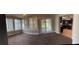Bright sunroom with sliding door access to the lanai, tile floors, and lots of natural light at 804 Wildwood Cir, Port Orange, FL 32127