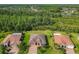 Aerial view of a single Gathering home neighborhood with ponds and mature trees at 819 San Raphael St, Kissimmee, FL 34759