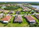 Aerial shot showcasing a residential area with spacious green lawns and serene lake views at 819 San Raphael St, Kissimmee, FL 34759