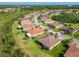A residential neighborhood with lush green lawns and terracotta tiled roofs, seen from above at 819 San Raphael St, Kissimmee, FL 34759