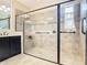 Updated bathroom showcases a glass-enclosed shower with tile surround and bronze hardware, adjacent to a vanity sink at 819 San Raphael St, Kissimmee, FL 34759