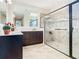 Bright bathroom features a spacious walk-in shower with glass enclosure and a double vanity with a large mirror at 819 San Raphael St, Kissimmee, FL 34759