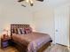 Comfortable bedroom with wood floors, ceiling fan, and a well-lit nightstand at 819 San Raphael St, Kissimmee, FL 34759