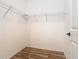 Empty closet with simple wire shelving installed, featuring neutral walls and wood-look vinyl flooring at 819 San Raphael St, Kissimmee, FL 34759