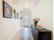 Bright entryway with tiled flooring, decorative console table, and ornate glass door at 819 San Raphael St, Kissimmee, FL 34759