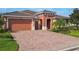 Lovely single-story home featuring a brick driveway, two-car garage, and neatly manicured lawn at 819 San Raphael St, Kissimmee, FL 34759