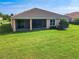 A view of the back of the house showing the tile roof and the screened-in porch at 819 San Raphael St, Kissimmee, FL 34759