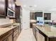 This spacious kitchen features a granite countertop island and stainless steel appliances, seamlessly connecting to the dining area at 819 San Raphael St, Kissimmee, FL 34759
