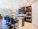 Gourmet kitchen boasting dark wood cabinetry, stainless steel appliances, and a spacious island with bar seating at 819 San Raphael St, Kissimmee, FL 34759