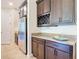 Modern kitchen featuring a stainless steel refrigerator, wine rack, and elegant granite countertops at 819 San Raphael St, Kissimmee, FL 34759