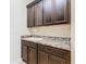 Well-equipped laundry area featuring dark cabinets, a utility sink, and countertop space above the washer and dryer at 819 San Raphael St, Kissimmee, FL 34759