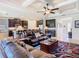 Cozy living room with comfortable seating, ceiling fan, and views into the kitchen and dining areas at 819 San Raphael St, Kissimmee, FL 34759