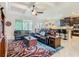Open-concept living room featuring tray ceilings, tile floors, and seamless flow to the kitchen at 819 San Raphael St, Kissimmee, FL 34759