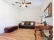 The home office features a comfortable leather couch, a ceiling fan and natural light at 819 San Raphael St, Kissimmee, FL 34759