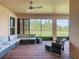 Relaxing screened patio featuring brick flooring and a comfortable seating area with a ceiling fan at 819 San Raphael St, Kissimmee, FL 34759