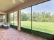 Screened-in patio featuring brick flooring and views of the lush backyard at 819 San Raphael St, Kissimmee, FL 34759