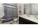 Clean bathroom with a shower-tub combo, a vanity with a sink, and a striped shower curtain at 9038 Pelican Cove Trce, Kissimmee, FL 34747