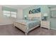 Serene bedroom with white furniture, complemented by stylish lamps and calming blue-green accents at 9038 Pelican Cove Trce, Kissimmee, FL 34747