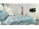 Comfortable bedroom featuring stylish bedding, a television and matching white dresser at 9038 Pelican Cove Trce, Kissimmee, FL 34747