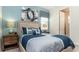 Comfortable bedroom featuring a queen-size bed, stylish decor, and soft lighting, creating a relaxing retreat at 9038 Pelican Cove Trce, Kissimmee, FL 34747