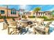 Outdoor common area featuring a stone fire pit surrounded by comfortable Adirondack chairs at 9038 Pelican Cove Trce, Kissimmee, FL 34747