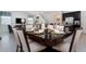 Elegant dining area with a modern table setting, seamlessly connected to the living room and kitchen at 9038 Pelican Cove Trce, Kissimmee, FL 34747