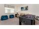 Inviting game room featuring plush beanbag chairs, a foosball table and a comfortable seating area at 9038 Pelican Cove Trce, Kissimmee, FL 34747