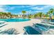 Relax poolside on the sun deck with comfortable loungers, umbrellas, and beautiful views of the pool at 9038 Pelican Cove Trce, Kissimmee, FL 34747