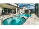 Spacious screened-in pool area, with a refreshing pool, relaxing spa, and comfortable lounge seating at 9038 Pelican Cove Trce, Kissimmee, FL 34747