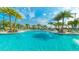 Bask in the sun by the community pool, complete with lounge chairs, palm trees, and relaxing fountains at 9038 Pelican Cove Trce, Kissimmee, FL 34747