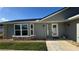 Charming home featuring a gray exterior, large window, and inviting walkway at 804 Wildwood Cir, Port Orange, FL 32127