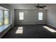 Spacious living room featuring gray carpet, natural light, and a ceiling fan at 804 Wildwood Cir, Port Orange, FL 32127