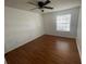 Spacious bedroom featuring wood floors, a large window, and neutral paint colors at 1027 S Hiawassee Rd # 2323, Orlando, FL 32835