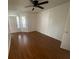 Spacious bedroom featuring hardwood floors, a ceiling fan, and bright natural light from windows at 1027 S Hiawassee Rd # 2323, Orlando, FL 32835