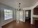 Dining room area featuring wood floors, a chandelier, and large window with view at 1027 S Hiawassee Rd # 2323, Orlando, FL 32835