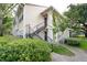 Charming exterior with well-maintained landscaping and convenient staircase access to upper units at 1027 S Hiawassee Rd # 2323, Orlando, FL 32835