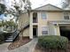 Two-story townhome featuring black door and stairs with a cozy, landscaped entrance at 1027 S Hiawassee Rd # 2323, Orlando, FL 32835