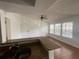 Bright kitchen featuring granite countertops with a breakfast bar and view of living area at 1027 S Hiawassee Rd # 2323, Orlando, FL 32835